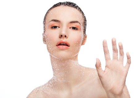 Beauty woman girl natural makeup looking through wet glass on white backgroundの写真素材