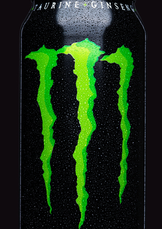 LONDON, UK - MARCH 15, 2017:  A can of Monster Energy Drink on black background. Introduced in 2002 Monster now has over 30 different drinks with high a caffeine content.のeditorial素材