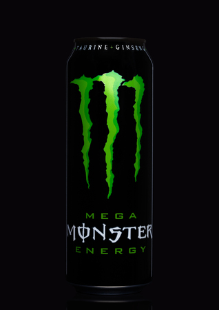 LONDON, UK - MARCH 15, 2017:  A can of Monster Energy Drink on black background. Introduced in 2002 Monster now has over 30 different drinks with high a caffeine content.のeditorial素材