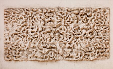 Ivory block grunge stone texture background with round deep holes shapeの写真素材