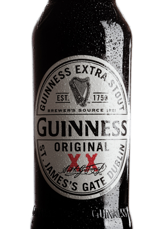 LONDON, UK - OCTOBER 15, 2017: Guinness extra stout beer bottle label on white background. Guinness beer has been produced since 1759 in Dublin, Ireland.のeditorial素材
