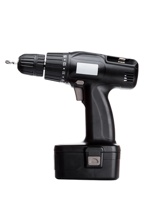 Black cordless drill with battery and drill bit on white backgroundの写真素材