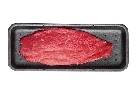 Fresh raw beef steak in black plastic container isolated on white backgroundの写真素材