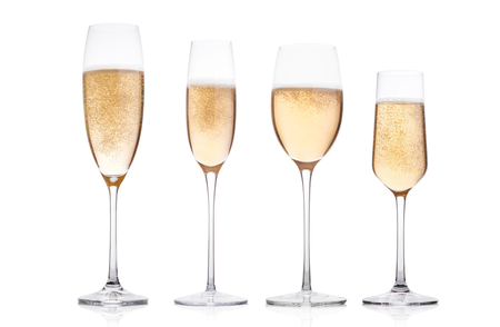Champagne glasses with bubbles on white background with reflectionの写真素材