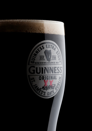 LONDON, UK - NOVEMBER 10, 2017: Glass of Guinness original beer on black background. Guinness beer has been produced since 1759 in Dublin, Ireland.のeditorial素材