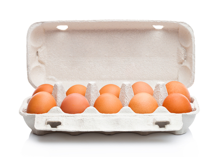 Raw farm fresh eggs in white paper tray isolated on white backgroundの写真素材