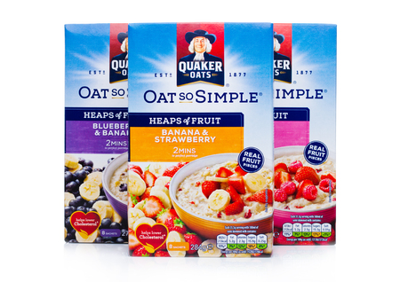 LONDON, UK - DECEMBER 15, 2017: Boxes of Quaker Oats porridge with and fruits on white background. It has been owned by PepsiCo since 2001.のeditorial素材