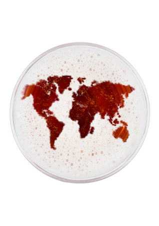 Glass of red ale beer top with earth map shape on white background top viewの写真素材