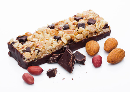 Chocolate protein cereal energy bar with almonds and peanuts white backgroundの写真素材