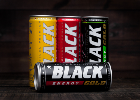 LONDON, UK - JANUARY 24, 2018: Aluminium cans of Black Energy Drink on wooden background.Leader on the energy market in Polandのeditorial素材