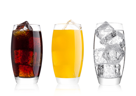 Glasses of cola and orange soda drink and lemonade sparkling water on white background with ice cubesの写真素材
