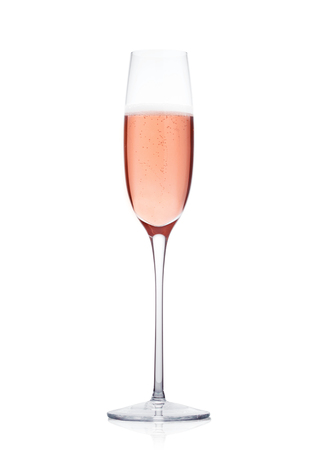 Rose pink champagne glass with bubbles isolated on white backgroundの写真素材