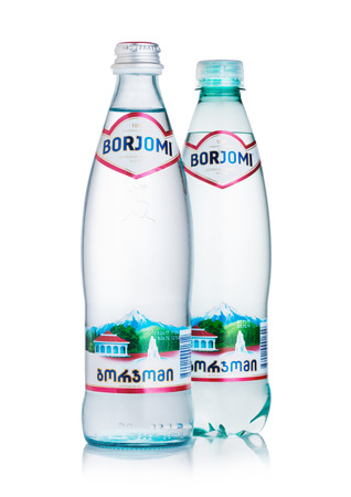 LONDON, UK - MARCH 10, 2018 : Glass and plastic bottle of Borjomi sparkling mineral water on white background.BORJOMI is born in Georgia.のeditorial素材