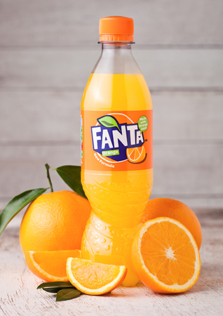 LONDON, UK - MARCH 31, 2018: Plastic bottle of Fanta orange soft drink on light wooden background...