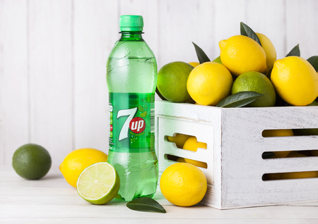 LONDON, UK - APRIL 27, 2018: Plastic bottle of 7UP lemonade soda drink with fresh lemons and...
