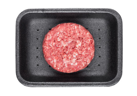 Raw fresh beef burger in plastic tray on white backgroundの写真素材