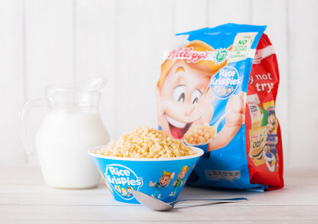 LONDON, UK - JUNE 01, 2018: Pack of Kellogg's Rice Krispies Breakfast Cereal with original plate and milk on white wooden background.のeditorial素材