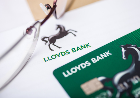 LONDON, UK - AUGUST 18, 2018: Lloyds Banking Group statement and credit card with glasses.のeditorial素材