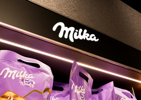 LONDON, UK - AUGUST 31, 2018: Milka chocolate display board with sign in food store.のeditorial素材