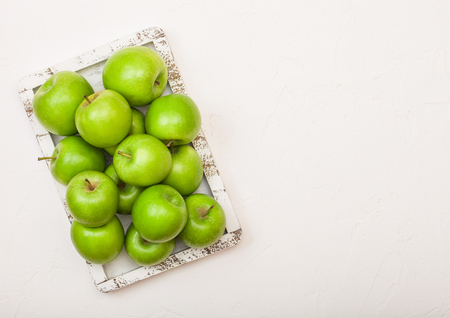 Green healthy organic apples in vintage box on wood backgroundの写真素材