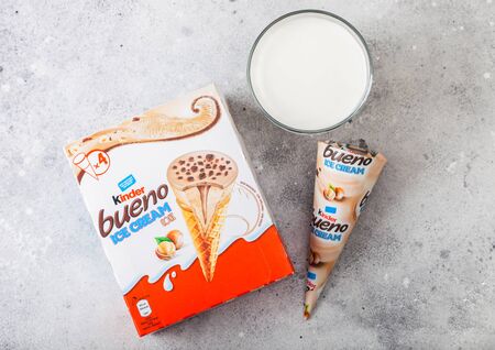 LONDON, UK - JUNE 05, 2019: Box of  Kinder Bueno chocolate ice cream cones on kitchen table with glass of milk.のeditorial素材