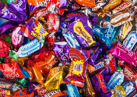 LONDON, UK - OCTOBER 10, 2019: Big Mix chocolate candies on white background. Quality Street,...