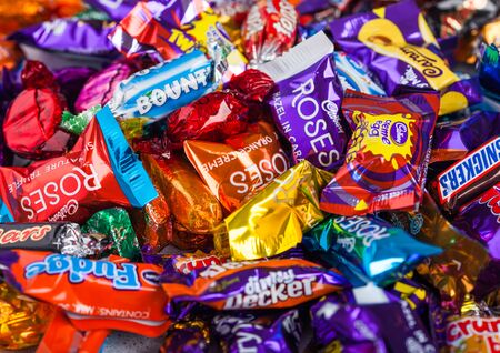 LONDON, UK - OCTOBER 10, 2019: Big Mix chocolate candies on white background. Quality Street, Celebrations, Roses and Heroesのeditorial素材