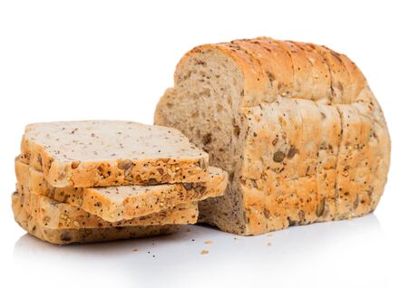 Cut of fresh loaf of seeded brown bread on white. Traditional bakery heritage.
