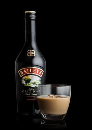 LONDON, UK - JUNE 02, 2020: Bottle and glass of Baileys Original Irish Cream on black background. Irish whiskey and cream based liqueur.のeditorial素材