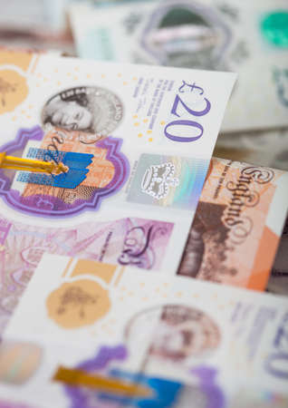New twenty, ten and five pounds banknotes close up on light background.Macro
