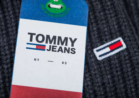 LONDON, UK - SEPTEMBER 09, 2020:Tommy Hilfiger logo and clothing tag on grey wool fabric.