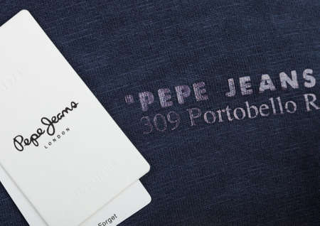 LONDON, UK - SEPTEMBER 09, 2020: Pepe Jeans label and clothing tag on dark cotton fabric.