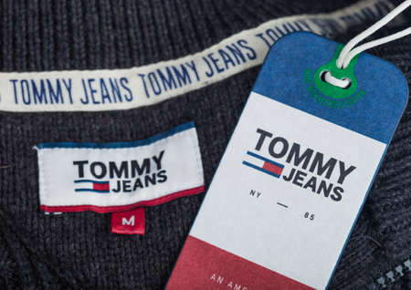 LONDON, UK - SEPTEMBER 09, 2020:Tommy Hilfiger label and clothing tag on grey wool fabric.のeditorial素材