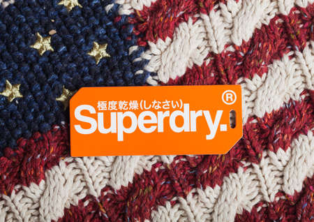 LONDON, UK - SEPTEMBER 09, 2020: Superdry label and clothing tag on wool fabric with amercan flag.