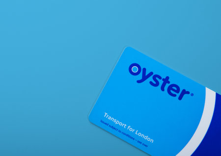 LONDON,UK - NOVEMBER 12, 2022: Oyster card on Blue background. Transport for london train ticket.Top...
