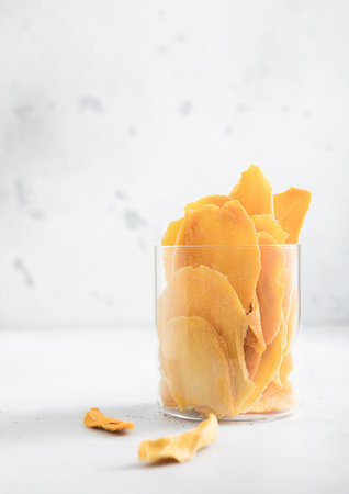 Glass jar with large sweet dried mango slices.Macroの写真素材