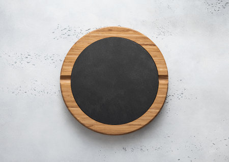 Round stone cutting board on light kitchen background.Top view.の写真素材