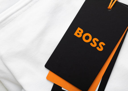 LONDON, UK - FEBRUARY 11, 2024: Boss orange label on premium white fabric t-shirt.のeditorial素材