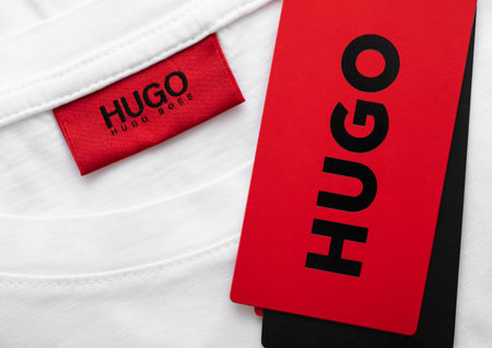 LONDON, UK - FEBRUARY 11, 2024: Hugo Boss red label tag on premium white fabric t-shirt.のeditorial素材