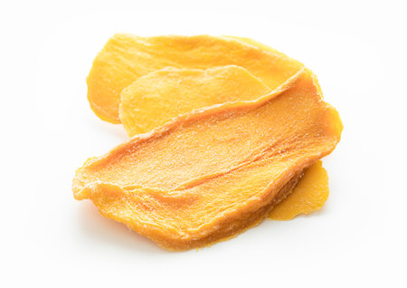 Slices of large sweet dried mangoes on white background.Mcaroの写真素材