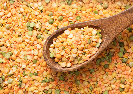 Wooden spoon with organic healthy peas assorted mix background.