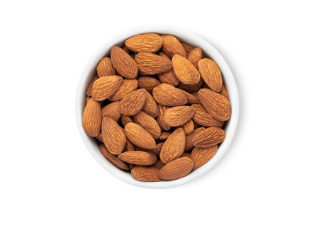 Bowl plate with healthy organic almond nuts isolated on white background.の写真素材
