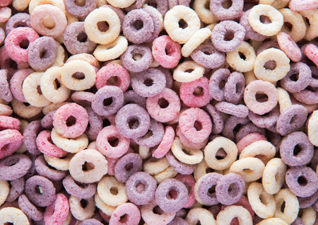 Macro shot of fruit circles cereal breakfast textured background with blueberry,banana and strawberry flavour.の写真素材