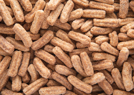 Sweet crunchy churros with sugar powder breakfast cereal textured background.の写真素材