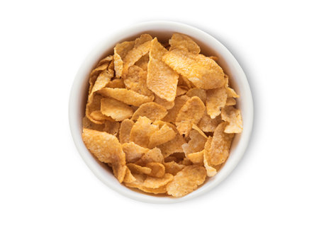 Top view bowl with original yellow corn flakes breakfast cereal on white.の写真素材