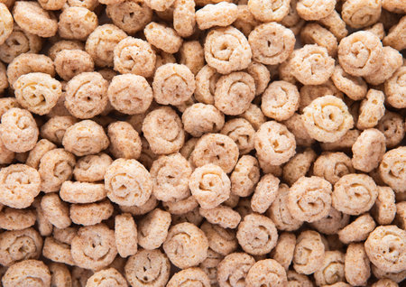 Crunchy mini cinnamon buns breakfast cereal textured background.の写真素材