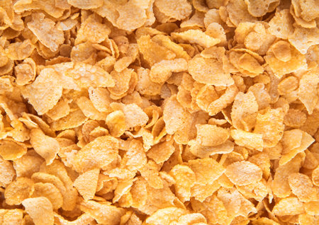 Original yellow healthy corn flakes breakfast cereal with vitamins textured macro shot.の写真素材