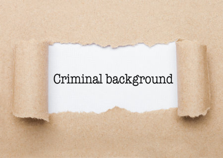 Criminal Background concept text appearing behind torn brown paper envelope
