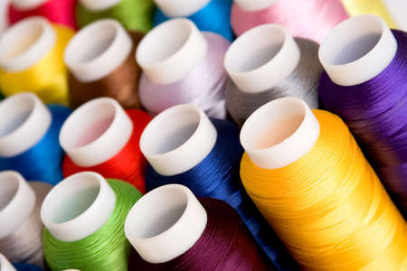 Hanks of multi-coloured threads for embroidery on a white backgroundの写真素材