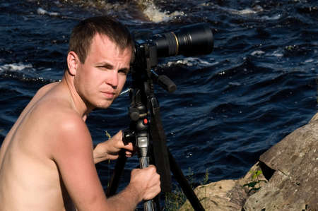 Professional photographer working on river bankの写真素材